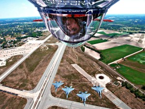 Pilot Ed Hamill turns his Air Force Reserve stunt plane upside down to get a better look at four F-15E Strike Eagles approaching from the rear.  Mr. Hamill was participating in a two-day air show on at Seymour Johnson Air Force Base, N.C., April 25 and 26 that attracted more than 100,000 spectators.  (U.S. Air Force photo)